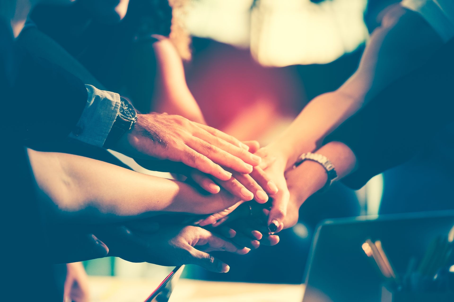 Diversity group of successful business people showing unity with their hands together, Image of businesspeople hands on top of each other as symbol of their partnership. Teamwork agreement concept. 